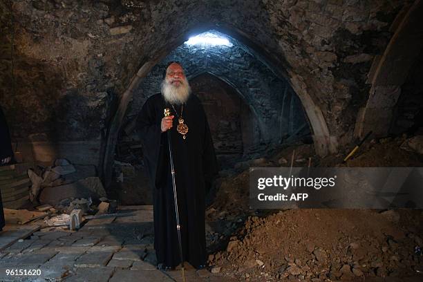 Coptic Archbishop Anba Abraham stands inside a disputed ancient basement adjacent to the Church of the Holy Sepulchre on November 3, 2009. An...