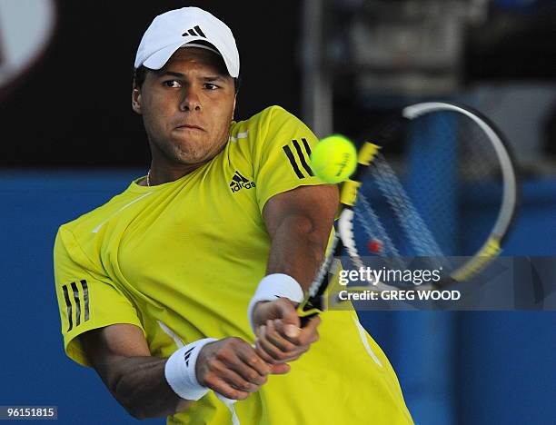 French tennis player Jo-Wilfried Tsonga plays a backhand return during his fourth round mens singles match against Spanish opponent Nicolas Almagro...
