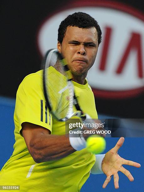 French tennis player Jo-Wilfried Tsonga plays a forehand return during his fourth round mens singles match against Spanish opponent Nicolas Almagro...