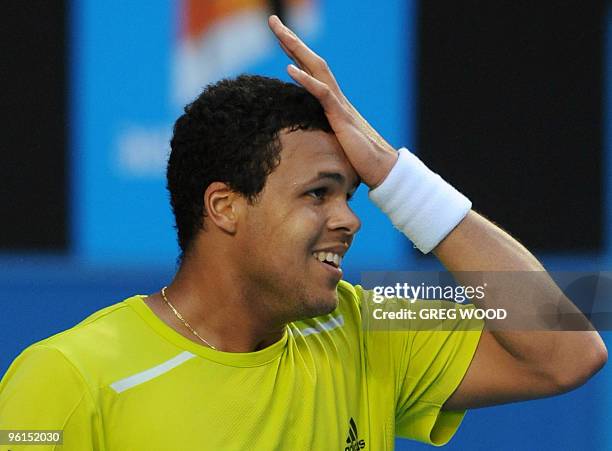 French tennis player Jo-Wilfried Tsonga gestures during his fourth round mens singles match against Spanish opponent Nicolas Almagro at the...