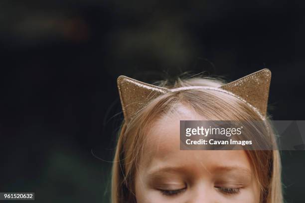 close-up of girl wearing cat ears headband outdoors - cat ears headband stock pictures, royalty-free photos & images