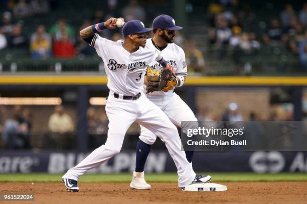 Orlando Arcia of the Milwaukee Brewers turns a double play next to Jonathan Villar in the third inning against the Arizona Diamondbacks at Miller...