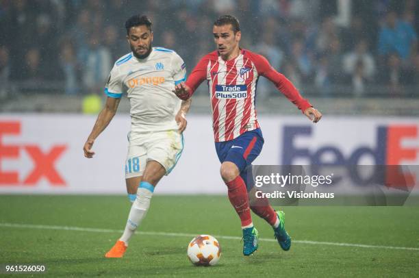 Antoine Griezmann of Atletico Madrid closes in on his second goal of the match chased by Jordan Amavi of Marseille during the UEFA Europa League...