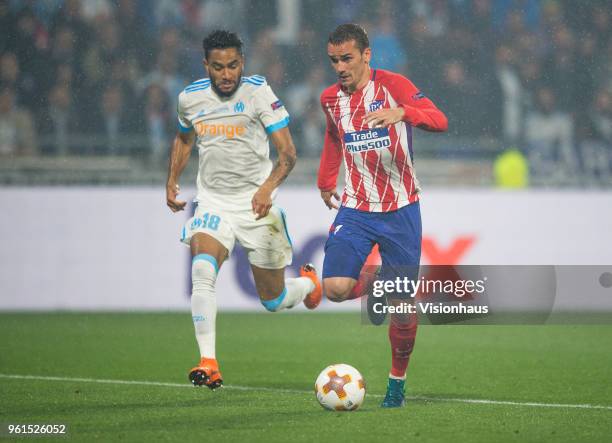Antoine Griezmann of Atletico Madrid closes in on his second goal of the match chased by Jordan Amavi of Marseille during the UEFA Europa League...