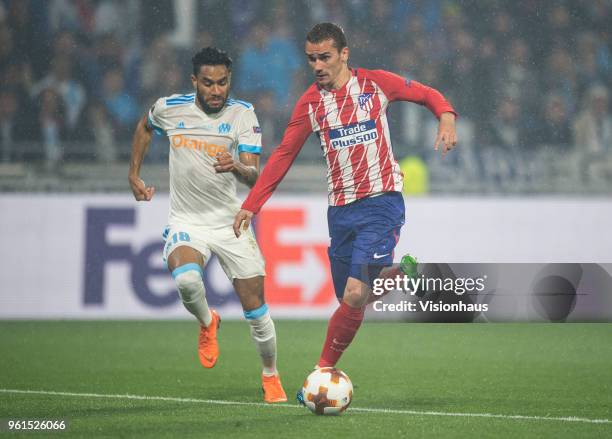 Antoine Griezmann of Atletico Madrid closes in on his second goal of the match chased by Jordan Amavi of Marseille during the UEFA Europa League...