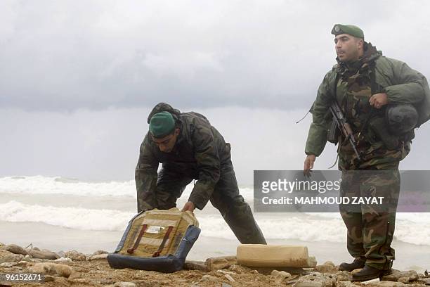 Lebanese army troops inspect the debris of an Ethiopian Boeing 737 that crashed off the Lebanese coast, south of the capital Beirut, on January 25,...