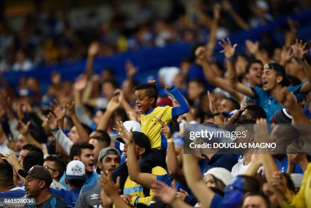 Supporters of Brazil's Cruzeiro cheer during the Copa Libertadores football match against Argentina's Racing Club at the Mineirao stadium in Belo...
