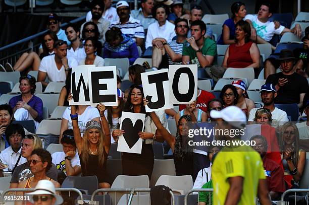 Spectators cheer for French tennis player Jo-Wilfried Tsonga during his fourth round men's singles match against Spanish opponent Nicolas Almagro at...