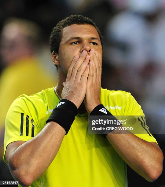 French tennis player Jo-Wilfried Tsonga gestures as he celebrates victory after his fourth round mens singles match against Spanish opponent Nicolas...