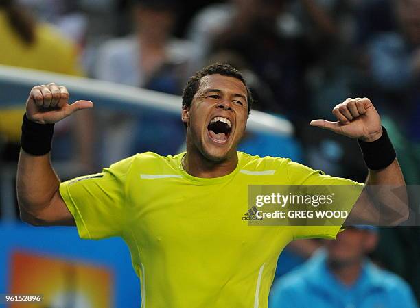 French tennis player Jo-Wilfried Tsonga gestures as he celebrates victory after his fourth round mens singles match against Spanish opponent Nicolas...