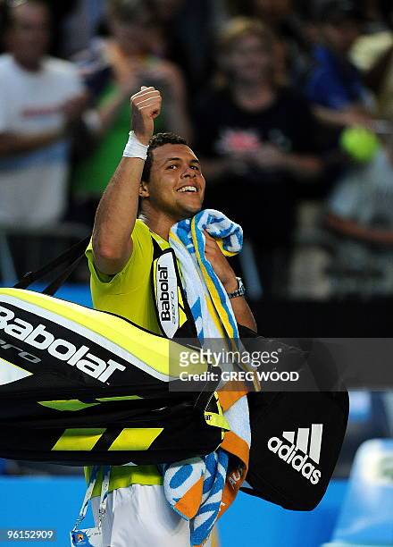 French tennis player Jo-Wilfried Tsonga gestures as he walks off the court after his fourth round mens singles match against Spanish opponent Nicolas...
