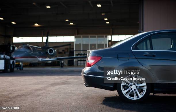 car parked at airplane hangar - private airplane hangar stock pictures, royalty-free photos & images