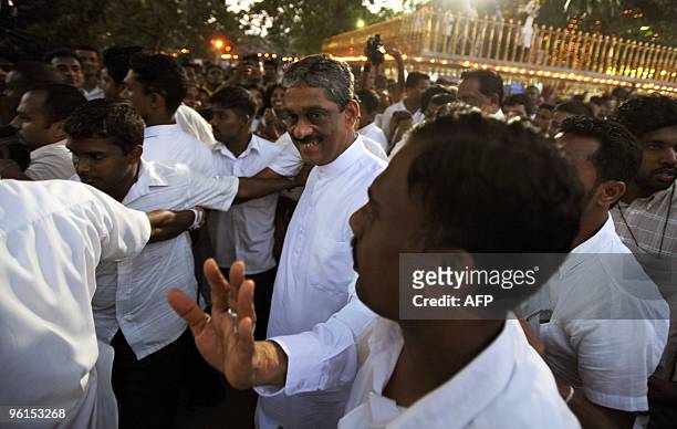 Sri Lanka's opposition presidential candidate Sarath Fonseka waves to supporters at the sacred temple of Kelaniya outside the capital Colombo on...
