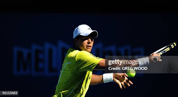 French tennis player Jo-Wilfried Tsonga plays a forehand return during his fourth round mens singles match against Spanish opponent Nicolas Almagro...