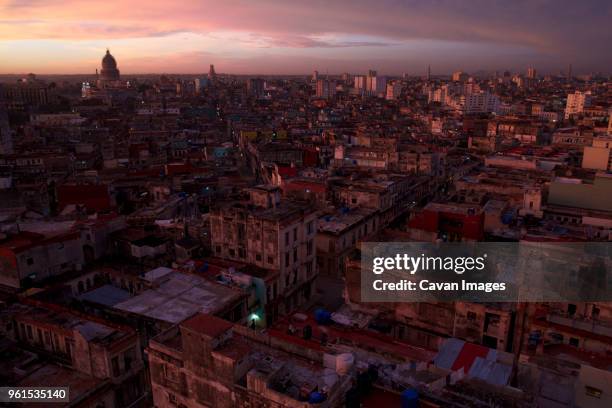 aerial view of cityscape with el capitolio against sky during sunset - havana city stock pictures, royalty-free photos & images