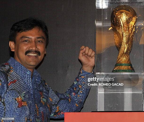 Indonesian Minister of Youth and Sports Andi Mallarangeng stands with the FIFA World Cup trophy during a ceremony in Jakarta on January 25, 2010. The...