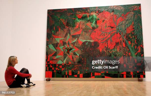 Woman views a painting by artist Chris Ofili entitled 'Afro Sunrise' exhibited in the Tate Britain gallery on January 25, 2010 in London, England....