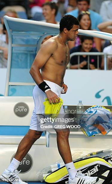 French tennis player Jo-Wilfried Tsonga walks on court during a break in his fourth round mens singles match against Spanish opponent Nicolas Almagro...
