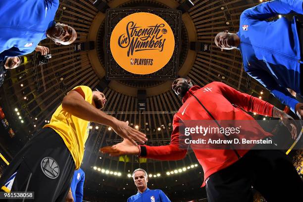 Stephen Curry of the Golden State Warriors and Tarik Black of the Houston Rockets shake hands at the start of the game in Game Four of the Western...