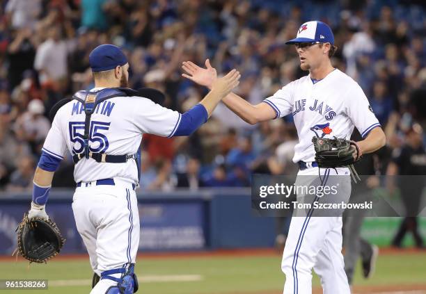 Tyler Clippard of the Toronto Blue Jays celebrates their victory with Russell Martin during MLB game action against the Los Angeles Angels of Anaheim...