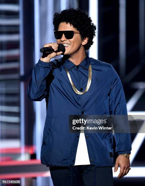 Singer Bruno Mars speaks onstage at the 2018 Billboard Music Awards at the MGM Grand Garden Arena on May 20, 2018 in Las Vegas, Nevada.