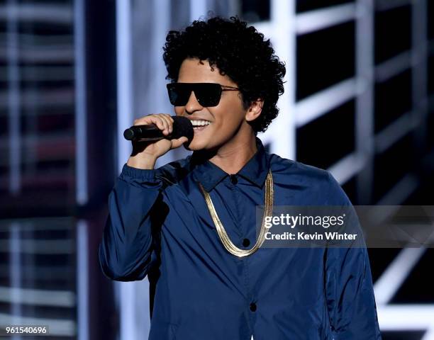 Singer Bruno Mars speaks onstage at the 2018 Billboard Music Awards at the MGM Grand Garden Arena on May 20, 2018 in Las Vegas, Nevada.