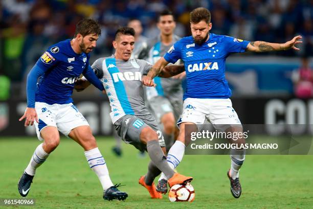 Lucas Silva and Rafael Sobis of Brazil's Cruzeiro vies for the ball with Ricardo Centurion of Argentina's Racing Club during their 2018 Copa...