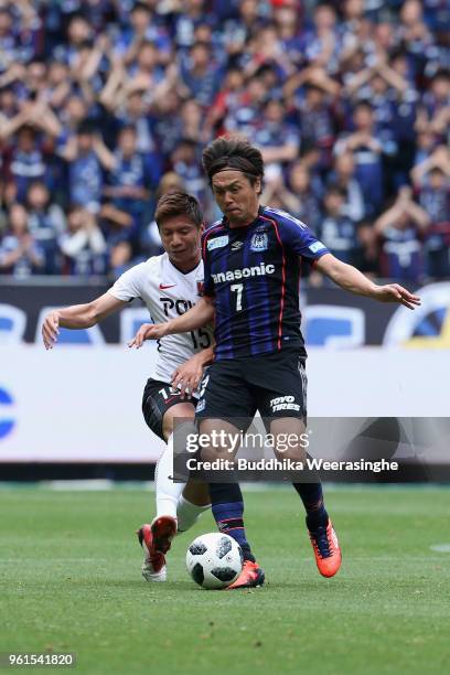 Yasuhito Endo of Gamba Osaka and Kazuki Nagasawa of Urawa Red Diamonds compete for the ball during the J.League J1 match between Gamba Osaka and...