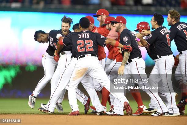 Michael A. Taylor of the Washington Nationals celebrates with teammates after hitting a game winning double in the bottom of the ninth inning against...