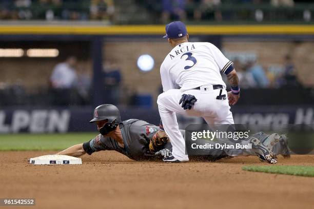 Orlando Arcia of the Milwaukee Brewers tags out Nick Ahmed of the Arizona Diamondbacks at second base during a steal attempt in the ninth inning at...