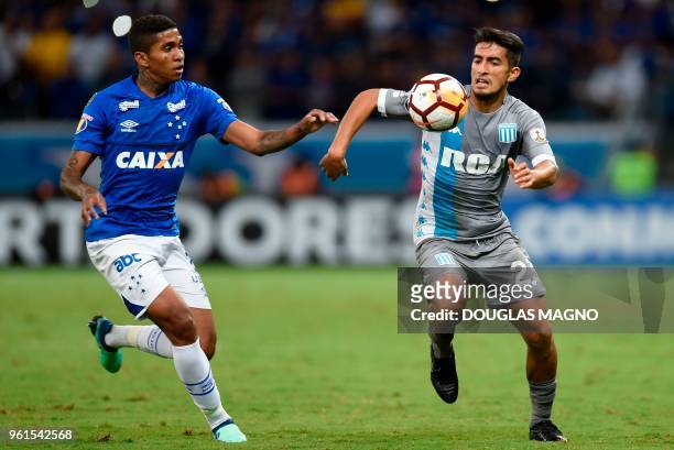 Raniel of Brazil's Cruzeiro vies for the ball with Alexis Soto of Argentina's Racing Club during their Copa Libertadores football match at the...