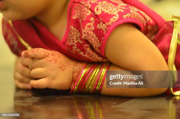 a baby girl getting ready in eastern dress for eif - ramadan 2017 india stock pictures, royalty-free photos & images