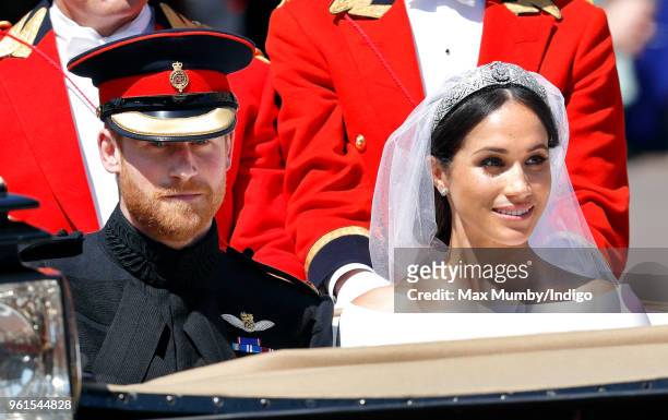 Prince Harry, Duke of Sussex and Meghan, Duchess of Sussex travel in an Ascot Landau carriage as they begin their procession through Windsor...