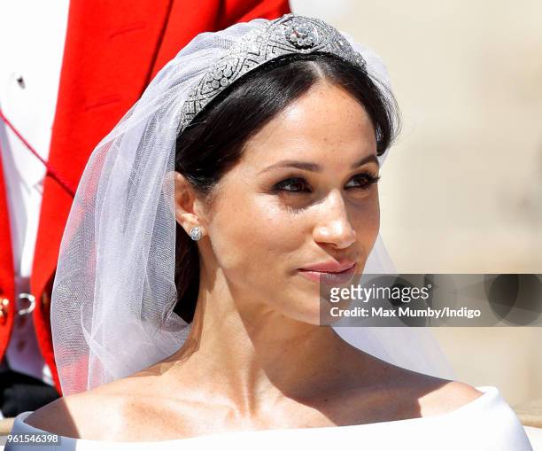 Meghan, Duchess of Sussex travels in an Ascot Landau carriage as she & Prince Harry, Duke of Sussex begin their procession through Windsor following...