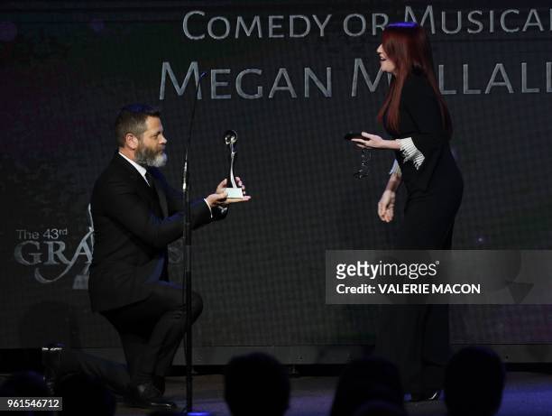 Nick Offerman gets down on one knee to present his wife actress Megan Mullally with the award for best supporting actress in a comedy or musical, on...