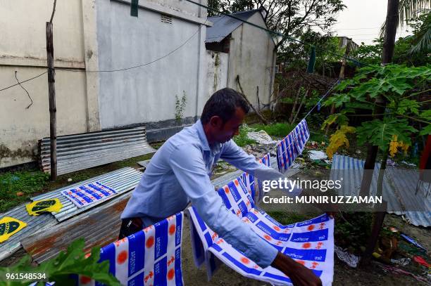 This photograph taken on May 17 shows Salim Hawalader, owner of a factory that produces national flags, hanging Argentine flags in Narayanganj, on...