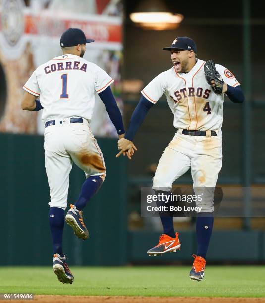 Carlos Correa and George Springer of the Houston Astros celebrate after the final out against the San Francisco Giants at Minute Maid Park on May 22,...