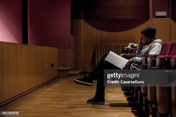 actor reading script for assistance during rehearsal - actor script stock pictures, royalty-free photos & images