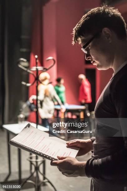 actor holding script during theatrical rehearsal - actor script stock pictures, royalty-free photos & images