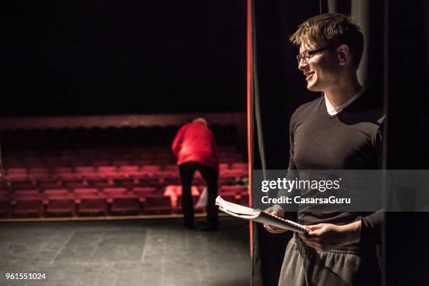 actor holding script during theatrical rehearsal - actor backstage stock pictures, royalty-free photos & images
