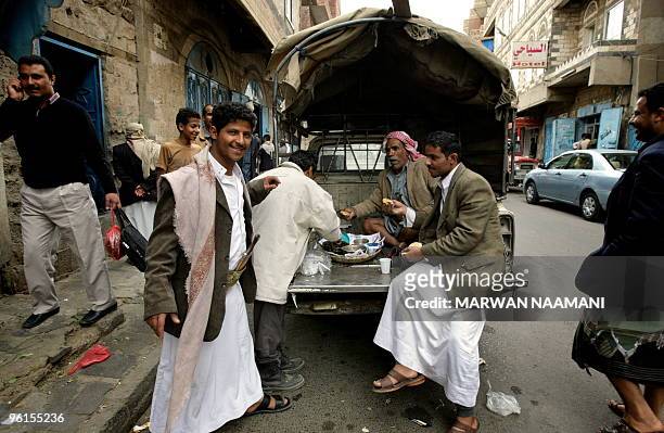 Yemenis have lunch in a street in Sanaa January 25, 2010. The United States is set to hold talks with European and Arab partners in London this week...