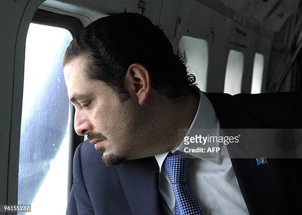 Lebanese Prime Minister Saad Hariri looks from the window of a helicopter looking for suvivors of an Ethiopian Boeing 737 that crashed off the...