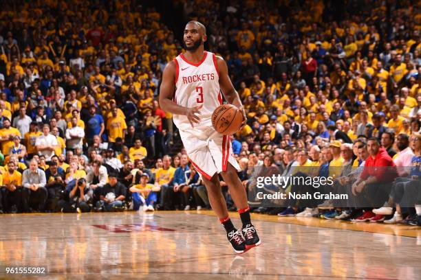 Chris Paul of the Houston Rockets handles the ball against the Golden State Warriors in Game Four of the Western Conference Finals of the 2018 NBA...