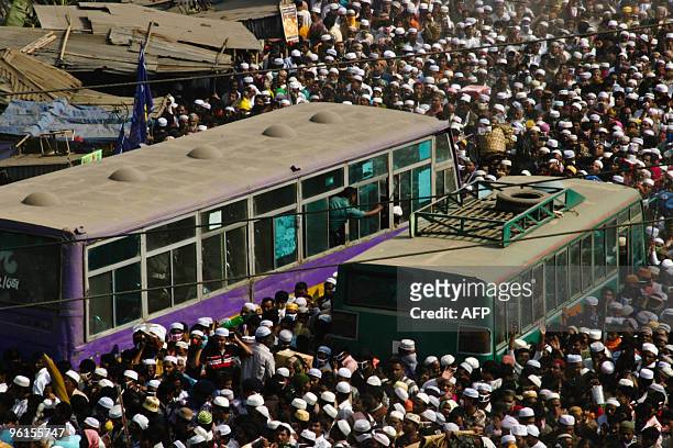 Muslim devotees spill onto a street following the conclusion of the Bishwa Itjema gathering in Tongi, near the capital Dhaka, on January 24, 2010. At...