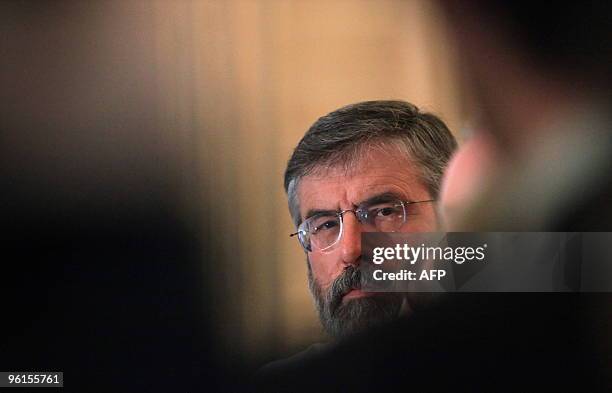 Sinn Fein President Gerry Adams listens to Northern Ireland's Deputy First Minister Martin McGuinness speak to the media before meetings with...