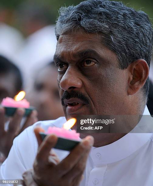 Sri Lanka's opposition presidential candidate Sarath Fonseka participates in the Buddhist religious act of 'prayer of determination' at the sacred...