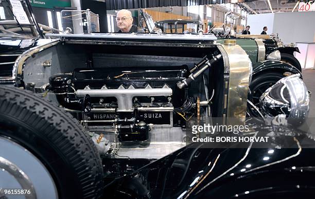 Visitor looks at Hispano Suiza displayed at Paris Retromobile show on January 22, 2010. The fair takes place from January 22 to January 31,...
