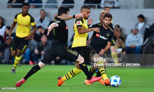 Jeremy Toljan of Borussia Dortmund vies for the ball with Diego Rossi and Aaron Kovar of LAFC during their international soccer friendly in Los...