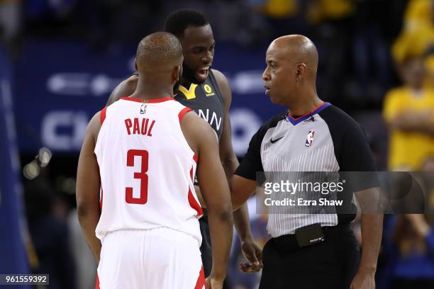 Draymond Green of the Golden State Warriors and Chris Paul of the Houston Rockets speak with referee Derrick Stafford during Game Four of the Western...