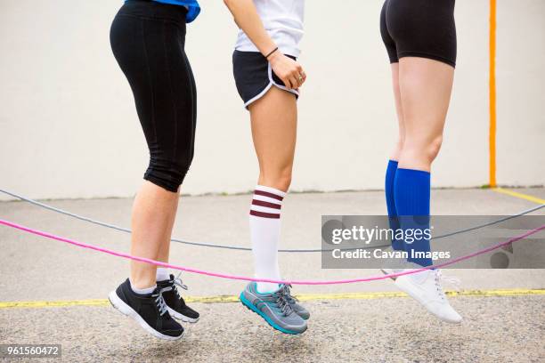 low section of women performing double dutch on street - waistdown stock pictures, royalty-free photos & images